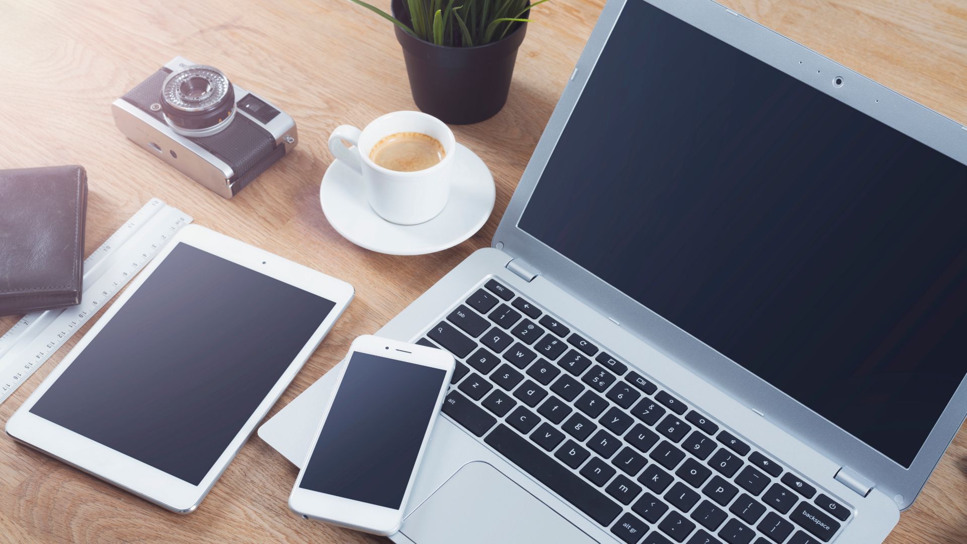 A picture of a desk with electrical devices that have Lithium-Ion batteries - Why You Should NEVER Put Lithium-Ion Batteries In A Skip